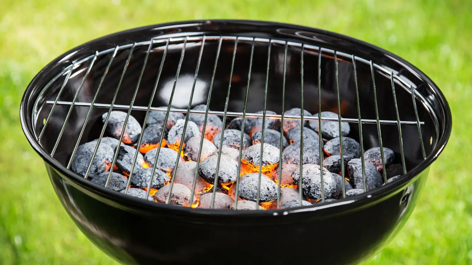 BBQ charcoal glowing evenly in a kettle grill